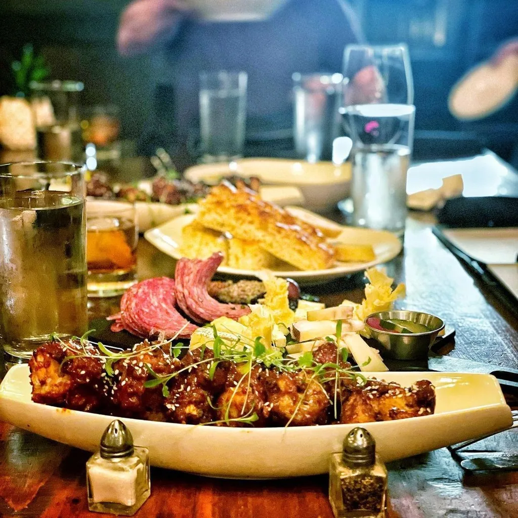 Bartender pouring cocktails in natural light
