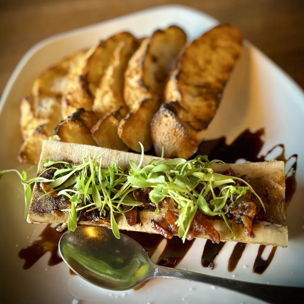 El Moro dining room with warm lighting and brick walls