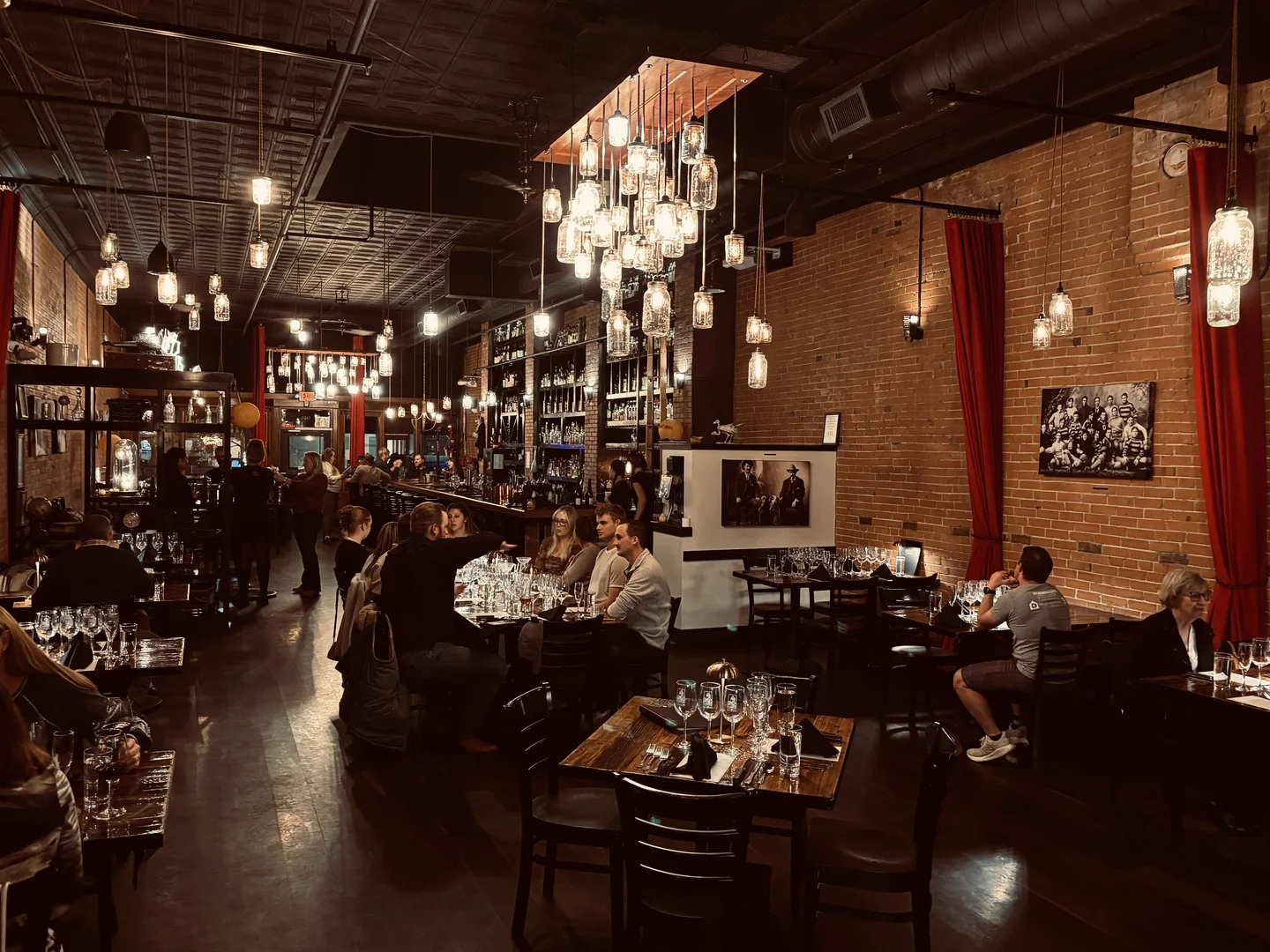 El Moro dining room with mason jar chandeliers and exposed brick